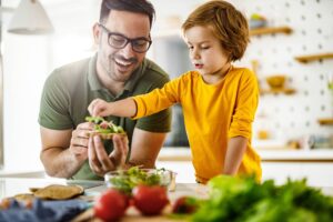 Father making sandwich with son