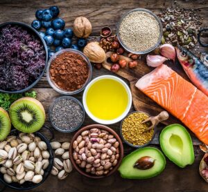Table with fresh grains, fish, and fruit