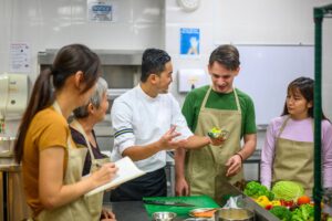 Cooks in the Kitchen learning from Chef
